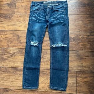 Machine distressed stretch denim jeans